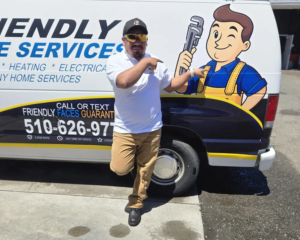 Friendly Services plumber next to the company van and mascot